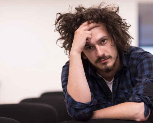 A student sits alone in a classroom