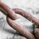 Rusty chain into the concrete